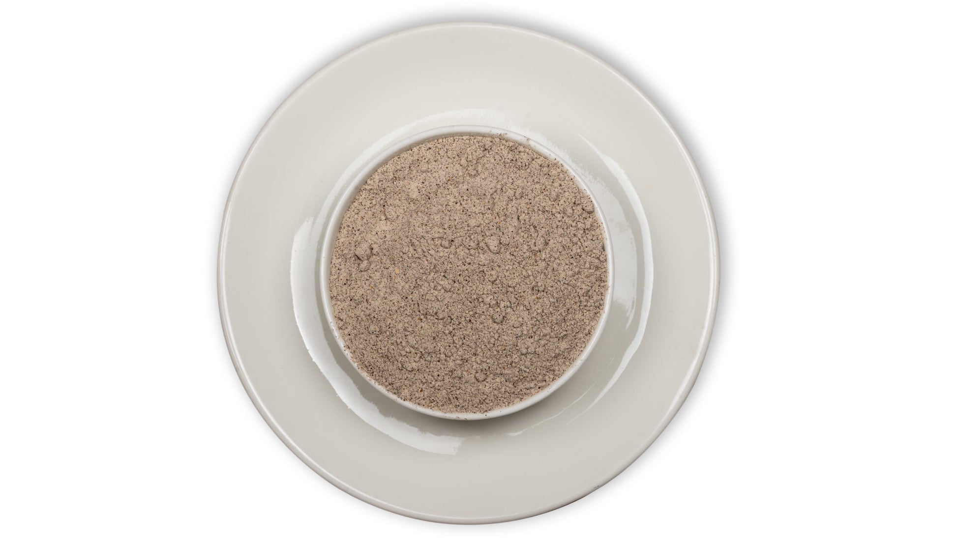 A bowl of Ragi flour (chemically free and pesticide free) on a white background, representing a healthy grain product.