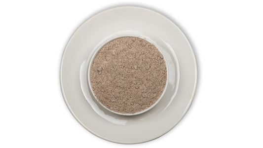 A bowl of Ragi flour (chemically free and pesticide free) on a white background, representing a healthy grain product.