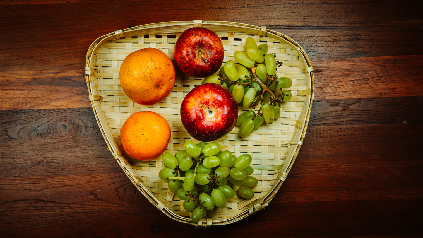 Triangular Fruit tray on dining table with fruits