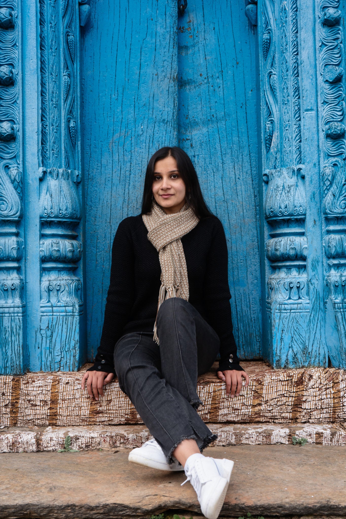 Reversible brown scarf outdoor in front of a Kumaoni home