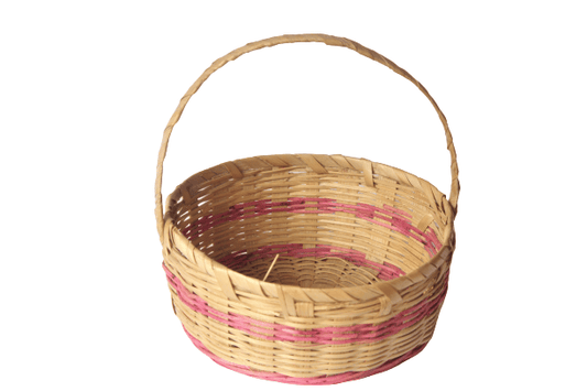 A handcrafted flower basket made of natural bamboo, with a handle, in a brown color with pink and black stripes.