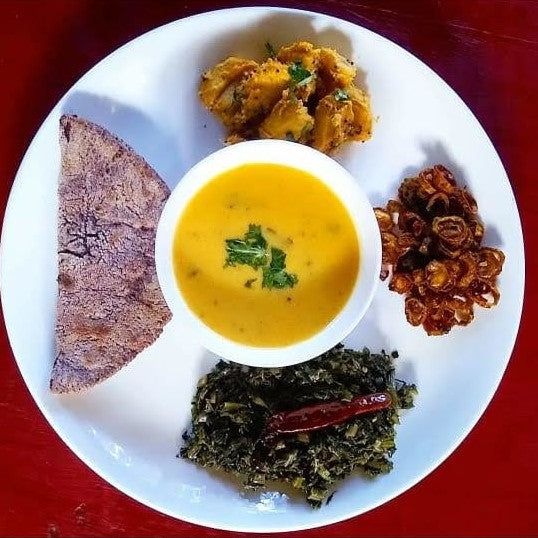 Madua Roti with Kadhi, Mustard greens, Aloo ke Gutke and bitter gourd chips