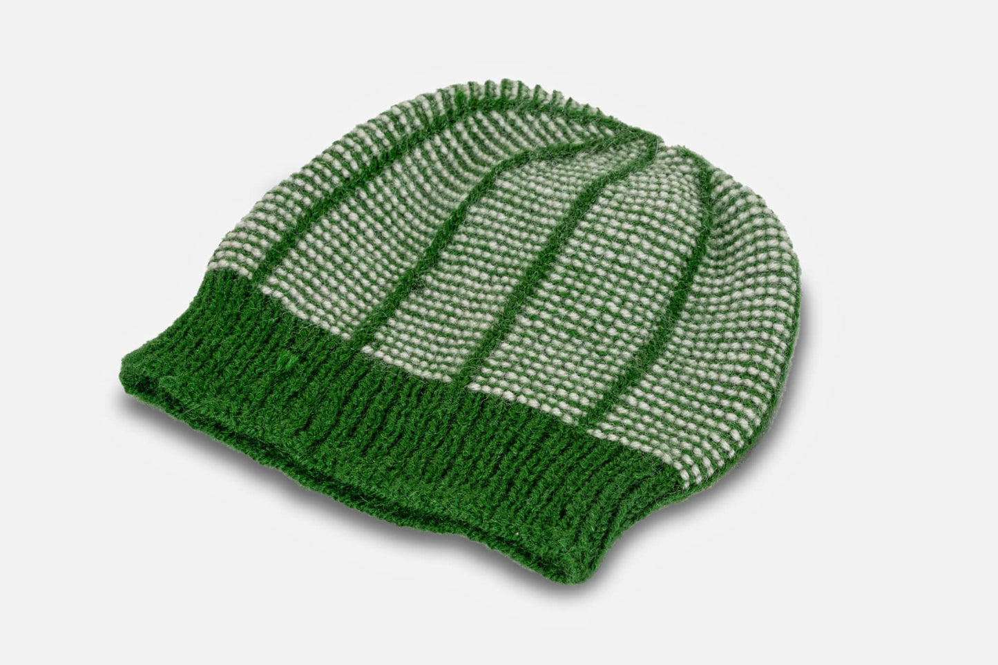 green handknitted acrylic yarn hat white background with shadow